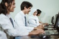 Indonesian high school students using computer pc with their friends studying in a computer lab room Royalty Free Stock Photo