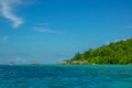 Island Covered with Jungle and Huts on the Water Royalty Free Stock Photo