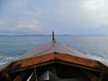 Indonesian local fishing wooden boat in the middle of the sea under the gray sky. Royalty Free Stock Photo