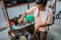 indonesian man adding soy sauce on fried rice Royalty Free Stock Photo