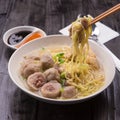 Indonesian Meatball Bakso Noodle with sweet soy sauce and chilli sauce sprinkle with green onion