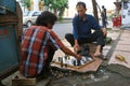 Indonesian men playing chess in the street. Royalty Free Stock Photo