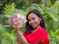 Indonesian money in the hands of an asian girl. Royalty Free Stock Photo