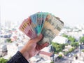 Indonesian money in the hands of a man. Royalty Free Stock Photo