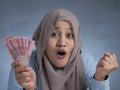 Indonesian Muslim Woman Holding Rupiah Money Royalty Free Stock Photo