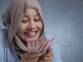 Indonesian Muslim Woman Holding Rupiah Money Royalty Free Stock Photo
