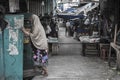Indonesian Muslim woman wearing the veil walks a back alley in Jakarta, Indonesia