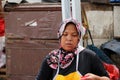 Indonesian muslim women chicken meat seller wearing a veil in the market at Muara Angke harbor