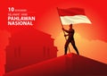 Indonesian National hero holding the flag of Indonesia on top of a building