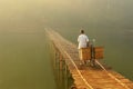 Indonesian old woman crossing the dangerous river