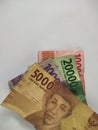 Indonesian paper money on white background.folded banknotes, business concept