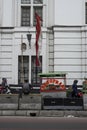 Indonesian people walk by street food stalls in a street near Kota in Jakarta , Indonesia