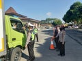 Indonesian police officer doing blocking in order to suppress the victims of covid19