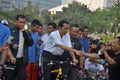 Indonesian President Joko Widodo while cycling greets residents Royalty Free Stock Photo