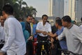 Indonesian President Joko Widodo while cycling greets residents Royalty Free Stock Photo