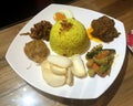 Indonesian Rice Dish Nasi Lemak Nasi Kuning Malaysian Food Fragrant Rice Dish Coconut Milk Pandan Leaf Shrimp Cracker Beef Rendang Royalty Free Stock Photo