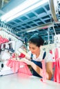 Indonesian Seamstress in Asian textile factory Royalty Free Stock Photo