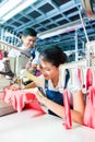 Indonesian Seamstress in Asian textile factory Royalty Free Stock Photo