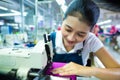 Indonesian seamstress in a textile factory