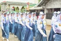 Indonesian students walking and marching on the street using uniforms in celebrating the country's Independence Day