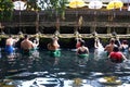 Indonesian and tourism pray and bath themselves in the sacred waters of the fountains, in Tirta Empul, Bali