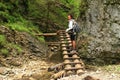 Tourist on wooden ladders in Slovak Paradise