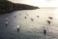 Indonesian traditional boats with outriggers Bangka at harbor in sunset.