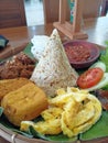 Indonesian traditional dishes called basi tutug oncom with fried tofu, tempeh, egg, and sambal