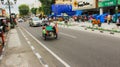 Indonesian Trishaw passing through the street