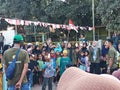Indonesian watching a competition "Lomba Makan Kerupuk" in celebrating Indonesia's Independence Day