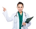 Indonesian woman doctor hold clipboard and finger point out Royalty Free Stock Photo