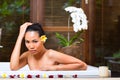 Indonesian woman having wellness bath in spa