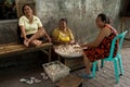 Indonesian woman peel garlic in Manado shantytown