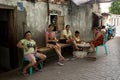 Indonesian woman peel garlic in Manado shantytown