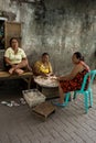 Indonesian woman peel garlic in Manado shantytown