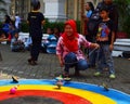 An Indonesian woman playing spinning top 'gasing' at the traditional games festival in 2013