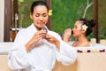 Indonesian women having wellness bath drinking tea