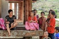 Indonesian women sit under the floor of tongkonan traditional house in Tana Toraja