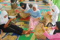 Indonesian women weave wicker handicrafts Royalty Free Stock Photo