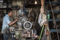 Indonesian worker operates his machine in an old worshop in Jakarta, Indonesia