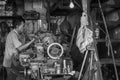 Indonesian worker operates his machine in an old worshop in Jakarta, Indonesia