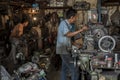 Indonesian workers operate their machines in an old workshop