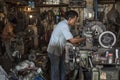 Indonesian workers operate their machines in an old workshop