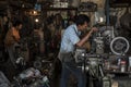 Indonesian workers operate their machines in an old workshop