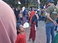 Indonesians watching a competition "Lomba Makan Kerupuk" in celebrating Indonesia's Independence Day