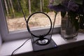 Indoor antenna for receiving TV signal. Set near the window and catches the TV. Details and close-up.