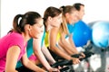 Indoor bycicle cycling in gym Royalty Free Stock Photo