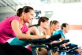 Indoor bycicle cycling in gym Royalty Free Stock Photo