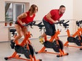 Indoor bycicle cycling in gym Royalty Free Stock Photo