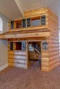 Indoor cabin playhouse for children made of brown logs built inside a house Royalty Free Stock Photo